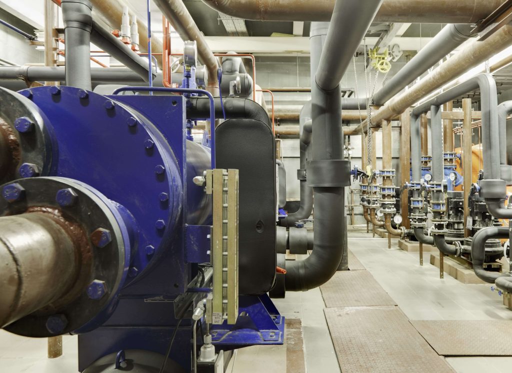 Industrial piping system with blue wafer-type ball valves installed in a compact process plant.