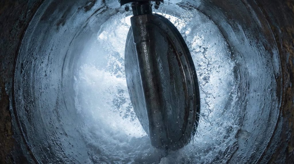 Butterfly valve disc operating under high-pressure water flow inside pipeline