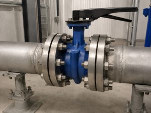 4 butterfly valve bolt size selection shown on a butterfly valve installed between flanges in an industrial piping environment with fasteners, valve body, and connection points clearly visible