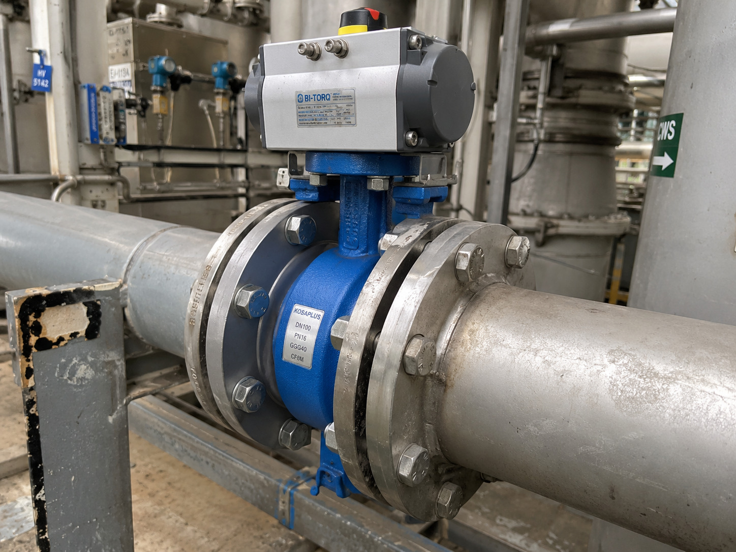 Butterfly Wafer Valve installed between pipeline flanges in an industrial process environment, showing the valve body, actuator, connected piping, and a technical procurement inspection scene.