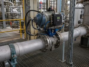Throttle butterfly valve control performance evaluated on an actuated butterfly valve installed in a realistic industrial process pipeline, with the valve body, rotary actuator, positioner, connected piping, and safe maintenance access clearly visible.
